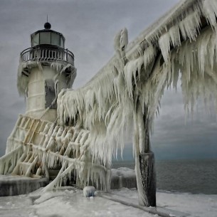 frozen lighthouse on Lake Michigan by thomas zakowski