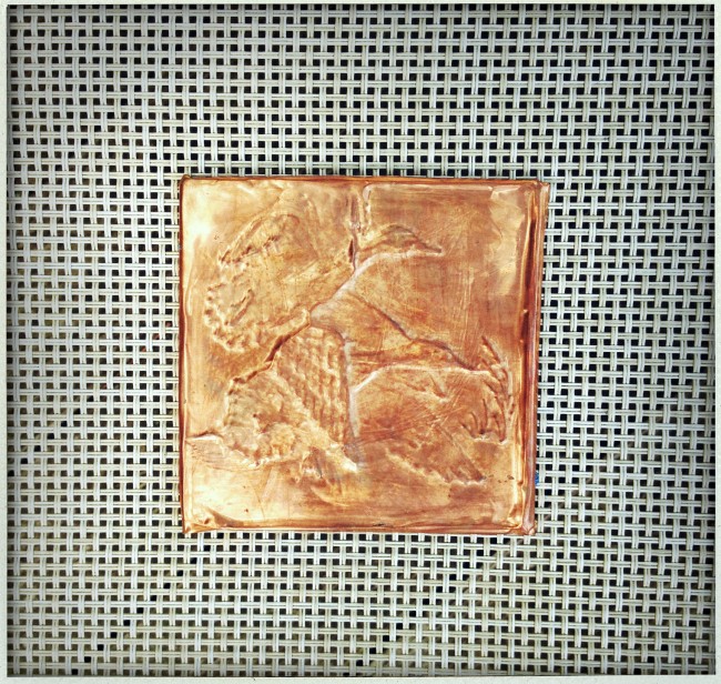 Two geese flying overhead, embossed in copper.