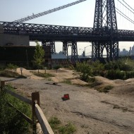 A dirt bike track with the Williamsburg Bridge in the background