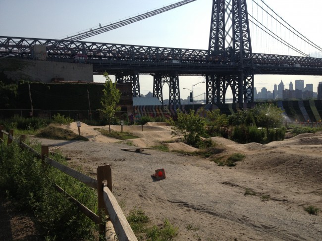 A dirt bike track with the Williamsburg Bridge in the background