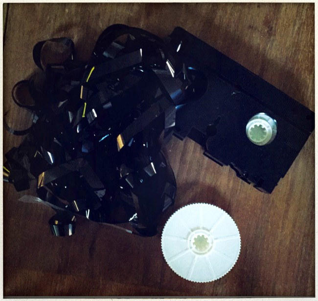 The deconstructed VHS tape, on the dining room table. How many of these do you still have aying around?